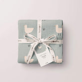 Minty duck swaddle folded and tied with tag and ribbon